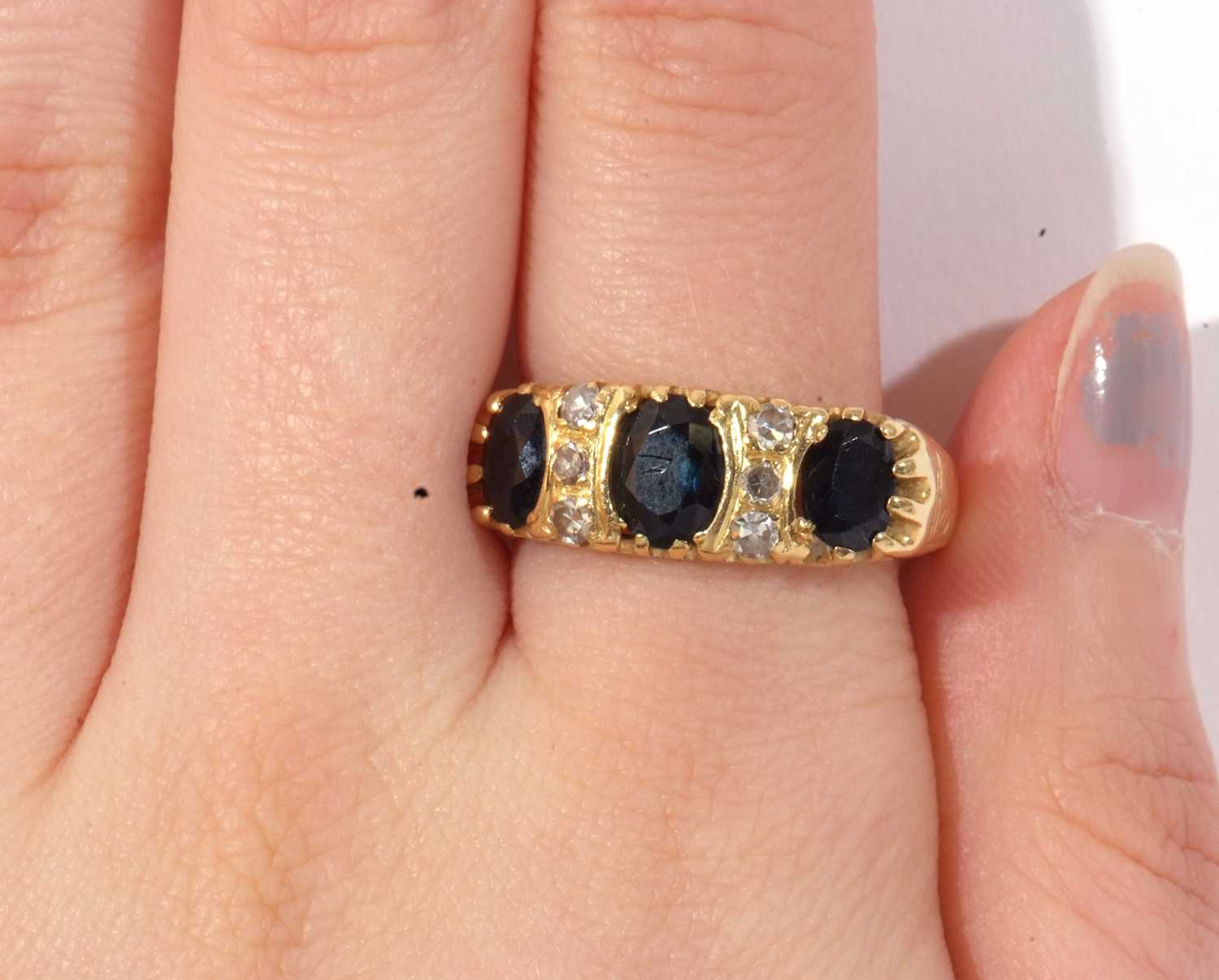 Sapphire and diamond ring featuring three graduated oval faceted sapphires highlighted between - Image 8 of 8