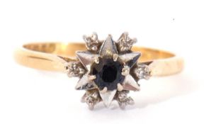 18ct gold sapphire and diamond ring centring a small faceted round sapphire raised above illusion