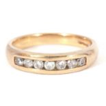 9ct gold and diamond half hoop ring featuring seven small channel set round cut diamonds, size N