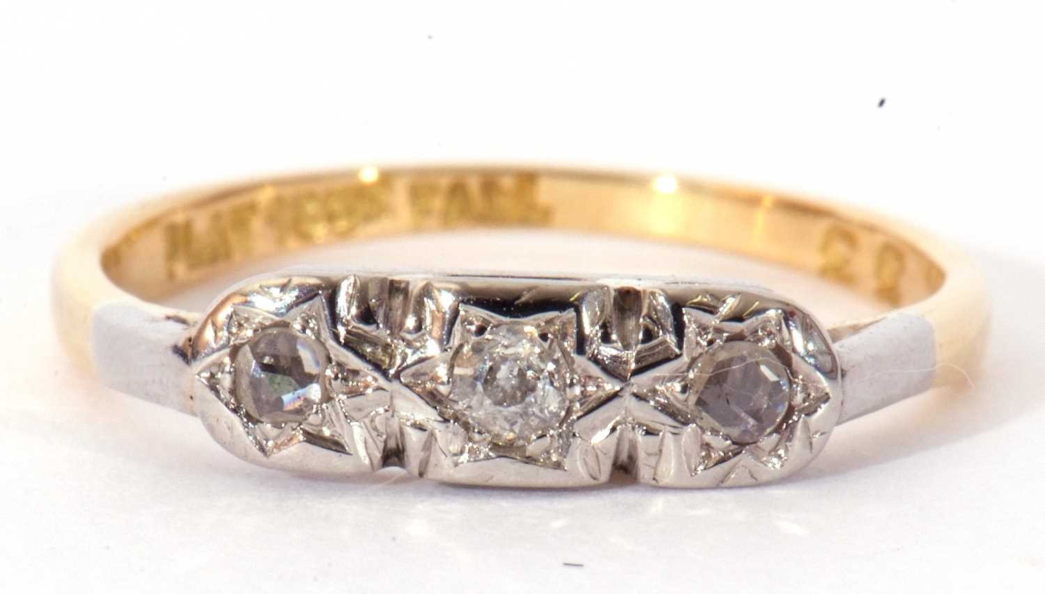 Three stone diamond ring, illusion set with three small mixed cut diamonds, stamped 18ct and Plat,