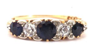 Sapphire and diamond ring featuring three round graduated sapphires and two round old cut