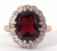 Modern 9ct gold garnet and diamond ring, the oval faceted garnet 12 x 10mm, in a small diamond set