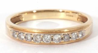 Modern 9ct gold and diamond half hoop ring, the top section set with nine small graduated single cut