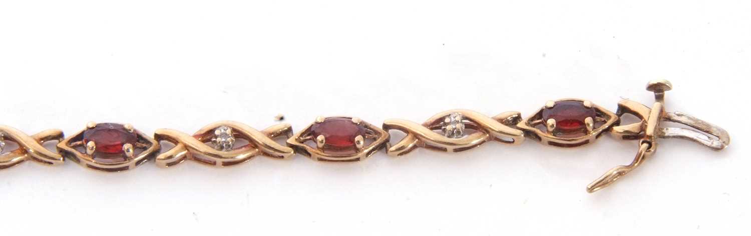 Modern 9ct gold and garnet small diamond line bracelet, alternate set with nine small oval cut - Image 5 of 6