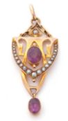 An amethyst and seed pearl open work pendant centring an oval faceted amethyst sitting above a