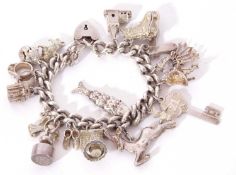 Silver curb link bracelet suspending various white metal charms, 108gms g/w