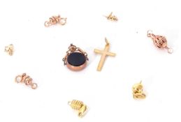 Mixed Lot: 9ct stamped cross pendant, a 9ct gold framed round swivel fob together with three