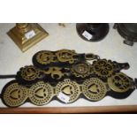 THREE STRAPS OF VARIOUS HORSE BRASSES