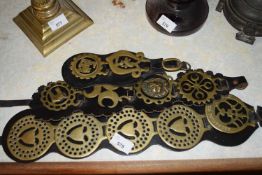 THREE STRAPS OF VARIOUS HORSE BRASSES