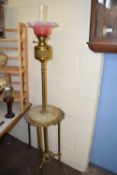 LARGE FLOOR STANDING COMBINATION OIL LAMP AND TABLE WITH BRASS FRAME, MARBLE INSET AND A FRILLED
