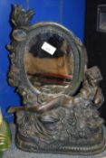 BRONZED COMPOSITION TABLE MIRROR WITH FIGURAL MOUNTS