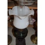 CAST METAL BASED OIL LAMP WITH GREEN GLASS FONT AND FRILLED SHADE