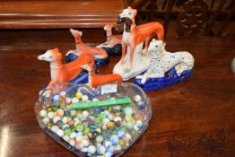 MIXED LOT VARIOUS STAFFORDSHIRE MODEL GREYHOUNDS AND A HEART SHAPED DISH CONTAINING VARIOUS MARBLES