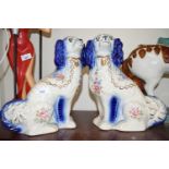 PAIR OF STAFFORDSHIRE STYLE FLORAL DECORATED MODEL SPANIELS