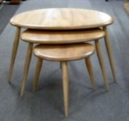 Ercol light elm nest of three pebble tables, largest 65cm wide