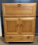 Ercol light elm bureau cabinet with fall front over two doors and a single base drawer, 182cm wide