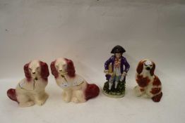 THREE VARIOUS STAFFORDSHIRE STYLE DOGS AND A FURTHER PORCELAIN FIGURE (4)