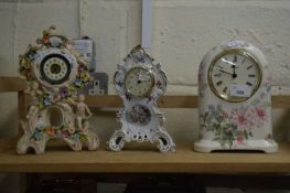 THREE MANTEL CLOCKS IN CERAMIC CASES