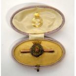 Gold metal Duke of Lancaster's Own Regimental brooch with enamelling to rose laurels and rim