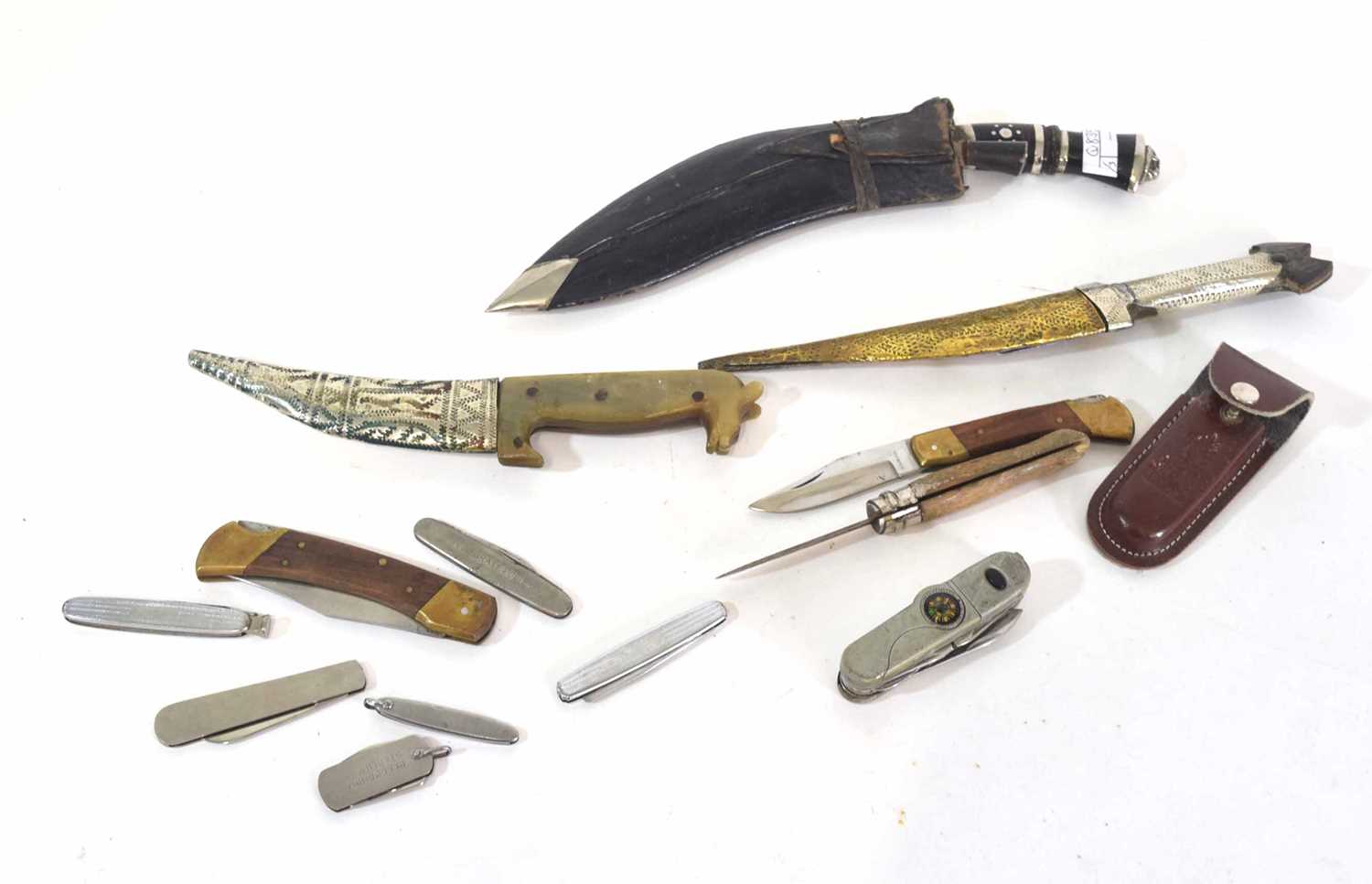 Quantity of 12 knives including Middle Eastern example, various pocket knives and Nepalese Kukri