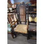 Late 17th/early 18th century oak high back chair with carved detail, the back inset with a cane