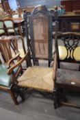 Late 17th/early 18th century oak high back chair with carved detail, the back inset with a cane