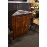 18th century walnut veneered corner cabinet with single door opening to a shelved interior, 63cm