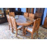 Kashmiri hardwood and floral carved dining room suite comprising an oval table with inset glass