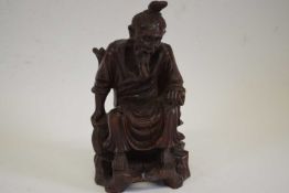 Chinese wooden carved figure of an immortal seated on a wooden dais, 18cm high