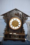 Dark wooden ornately carved cuckoo clock together with carved wooden shelf carved with an eagle,