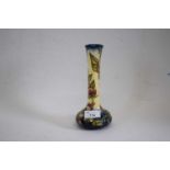 A modern Moorcroft vase with typical tube lined floral decoration21cm highGood condition