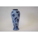 A Moorcroft vase with a tube lined floral pattern on a blue ground.20cm highGood condition