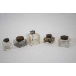 Small box containing five glass inkwells with metal covers