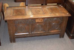 18th century oak coffer with three panelled top over a front with three carved panels raised on