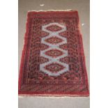 Small Middle Eastern wool floor rug with pale blue central panel surrounded by a dark red