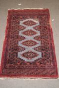 Small Middle Eastern wool floor rug with pale blue central panel surrounded by a dark red