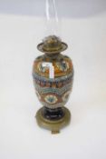 Lambeth Doulton oil lamp with glass chimney (crack to top), the lamp 32cm high