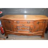 Late 19th century oak sideboard in the Arts & Crafts style, the bowed front with three doors and a