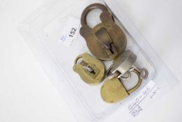 Box containing four small vintage padlocks with keys