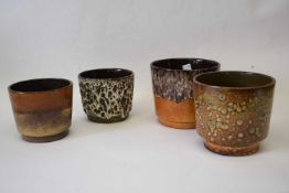 Group of four West German pottery plant holders, all with typical mottled designs, largest 17cm diam