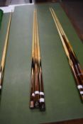 Three Powerglide cues marked Connoisseur, with facsimile signature for Rex Williams, 147cm long