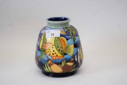 A modern Moorcroft vase with tube lined decoration in the Martinique pattern15cm highGood condition