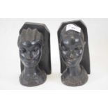 Two African tribal art carvings, heads modelled as bookends, probably West African, (2)
