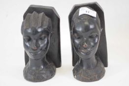 Two African tribal art carvings, heads modelled as bookends, probably West African, (2)