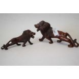 Two carved wooden models of lions with glass eyes