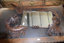 Late 19th/early 20th century Continental wall mirror with shaped carved wooden surround formed as
