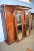 Victorian mahogany break front wardrobe with moulded cornice over two central mirrored doors and two