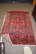 20th century Middle Eastern wool floor rug decorated with a large central panel with lozenges and