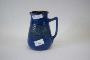 Barnstaple Pottery blue glazed jug with Art Deco motif decoration in green, 17cm high