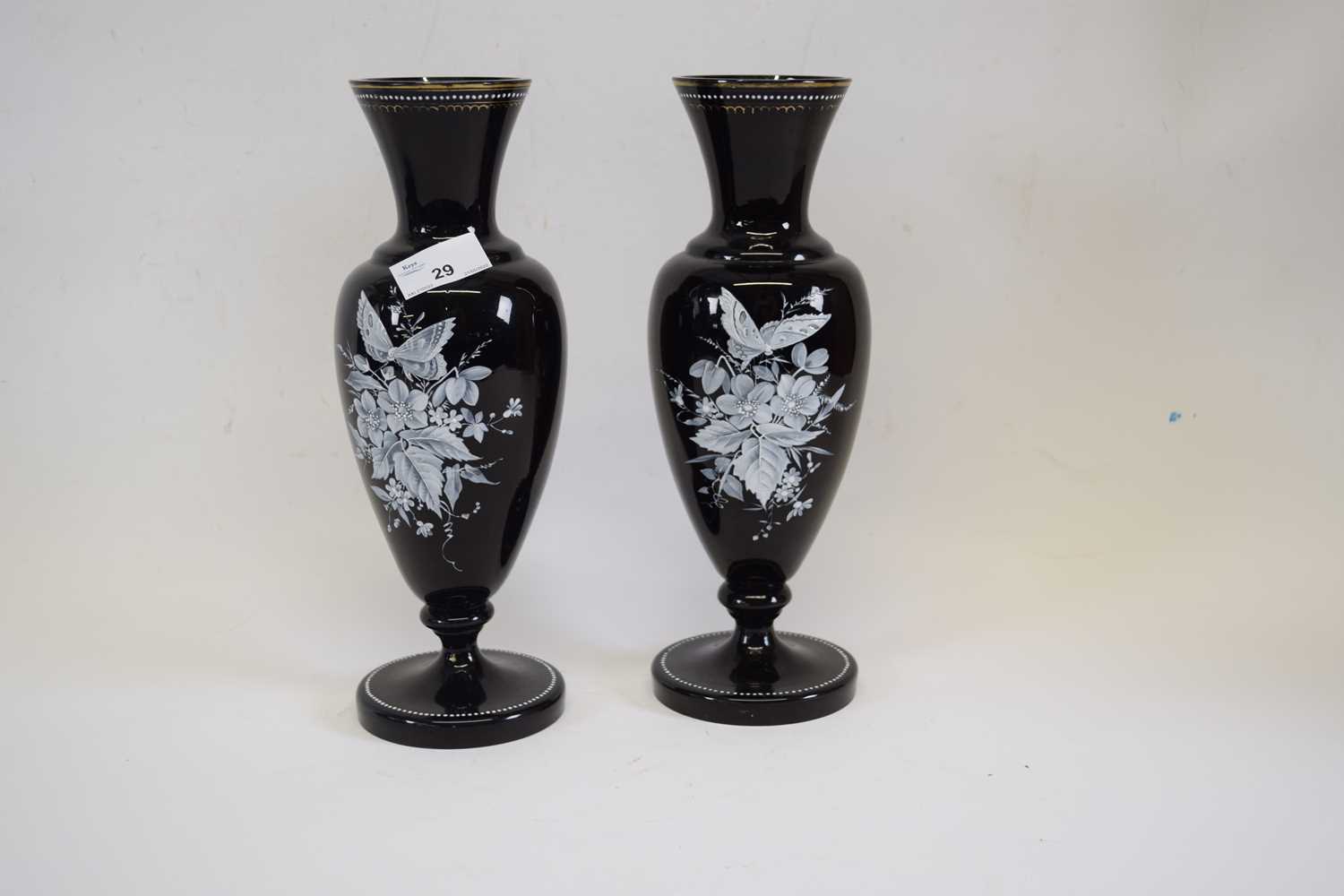 Pair of Victorian black coloured glass vases, finely painted with a floral spray and butterflies,